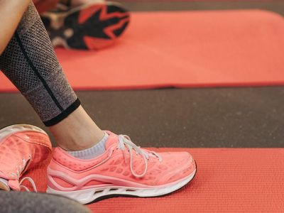 Close-up on athletic shoes on a yoga mat.