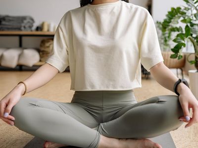 Person sitting calmly, focusing on breathing before a workout.